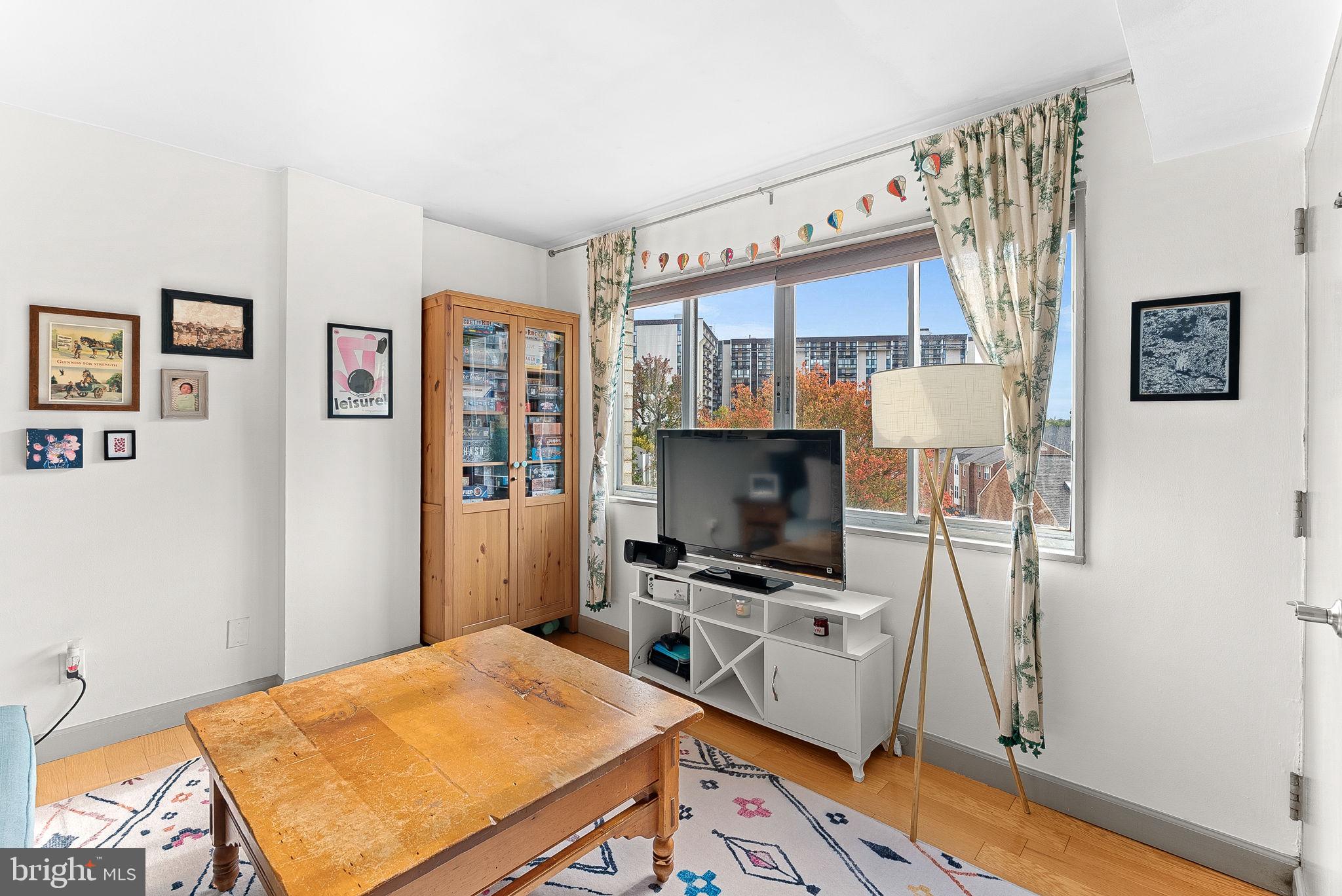 5340 Holmes Run Parkway, Unit 400 Alexandria, VA 22304 - Photo 8 of 40 a bedroom with a bed and a flat screen tv