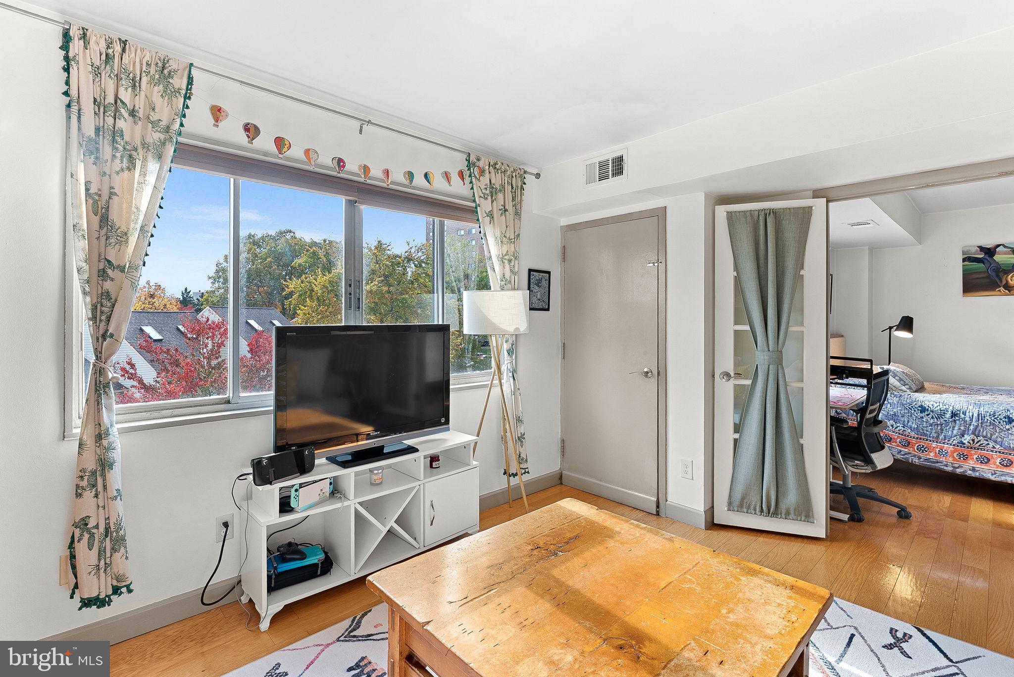 5340 Holmes Run Parkway, Unit 400 Alexandria, VA 22304 - Photo 9 of 40 a room with furniture and flat screen tv