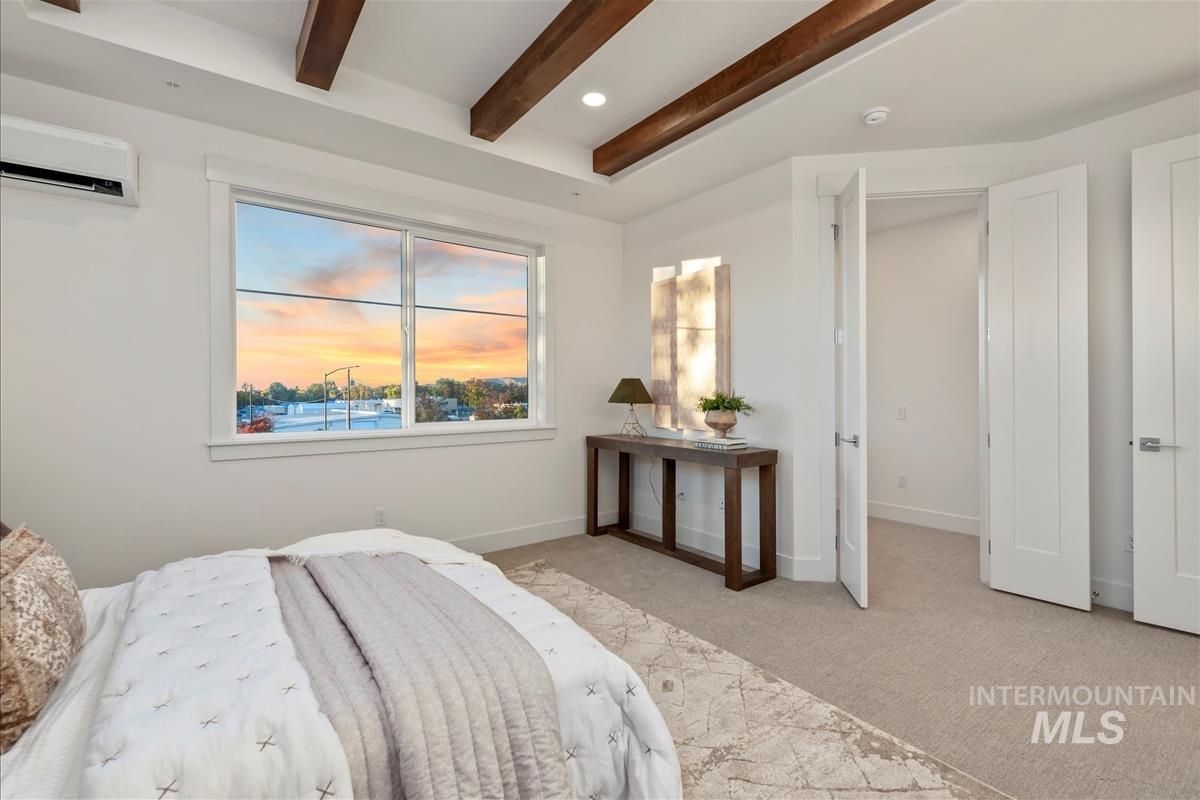 3243 West Moore Street Boise, ID 83702 - Photo 14 of 38 Bedroom featuring light colored carpet, beamed ceiling, a wall mounted AC, and recessed lighting