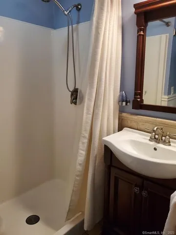 a bathroom with a sink a mirror and a shower