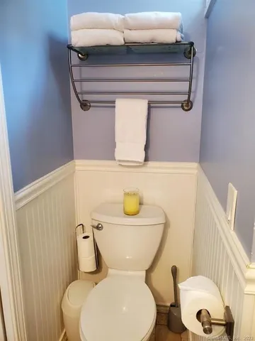 a white toilet sitting next to a bathroom sink