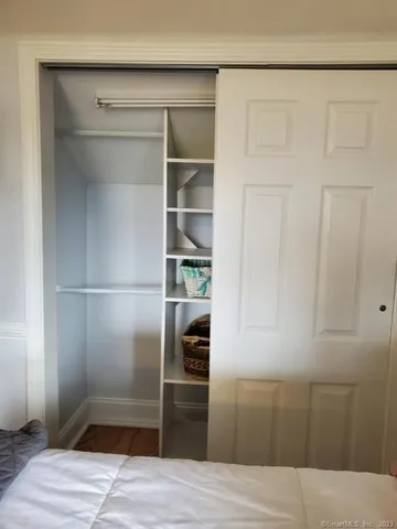 a kitchen with a refrigerator and wooden floor