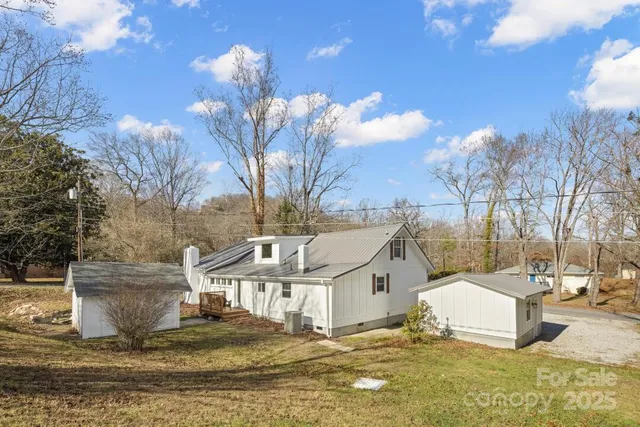 a view of a white house with a yard