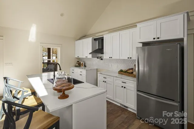 a kitchen with a sink appliances and cabinets