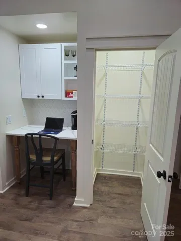 a workspace with wooden floor and a cabinet