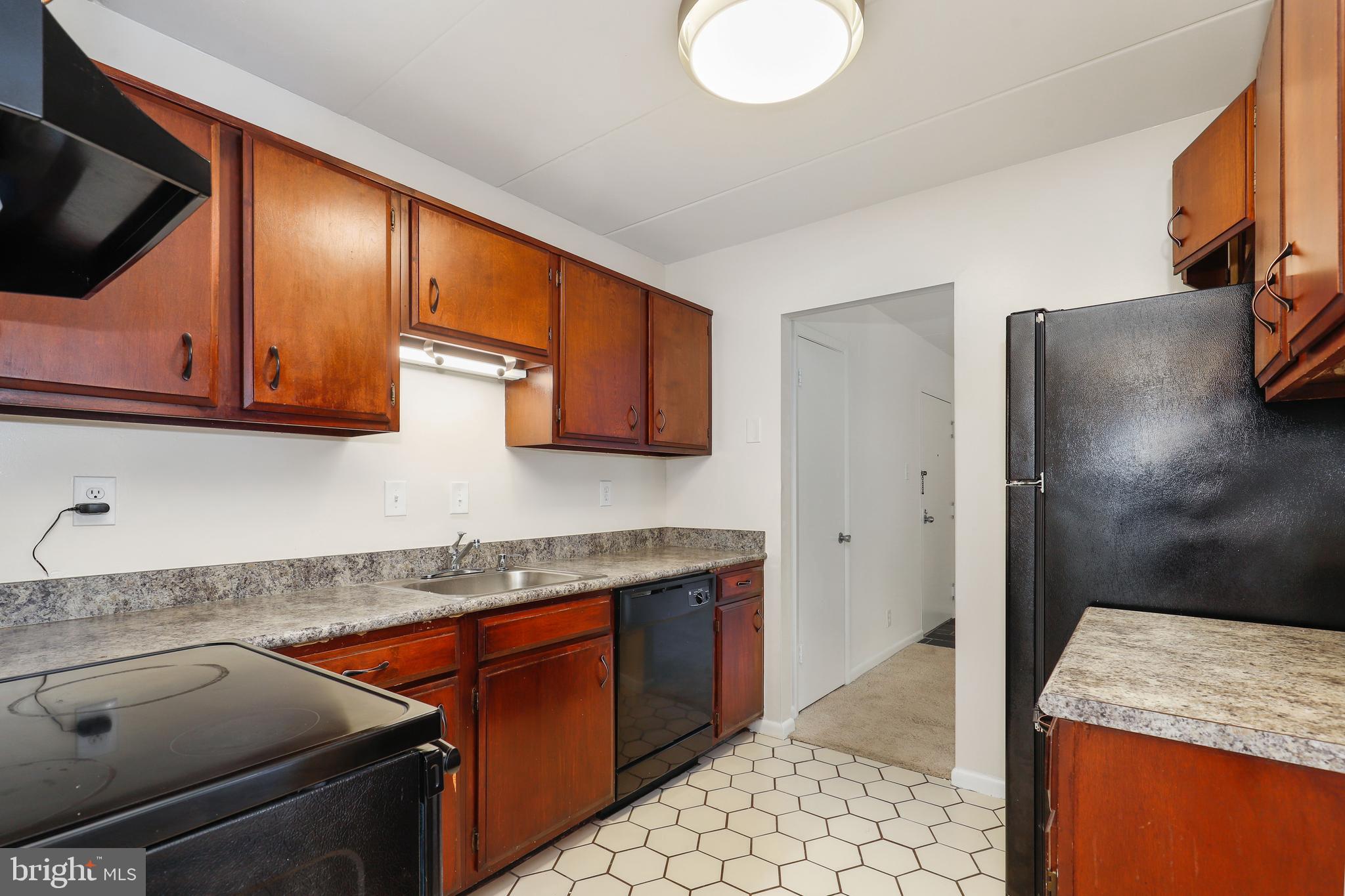 6250 Edsall Road, Unit 203 Alexandria, VA 22312 - Photo 12 of 31 a kitchen with stainless steel appliances granite countertop a sink stove and refrigerator