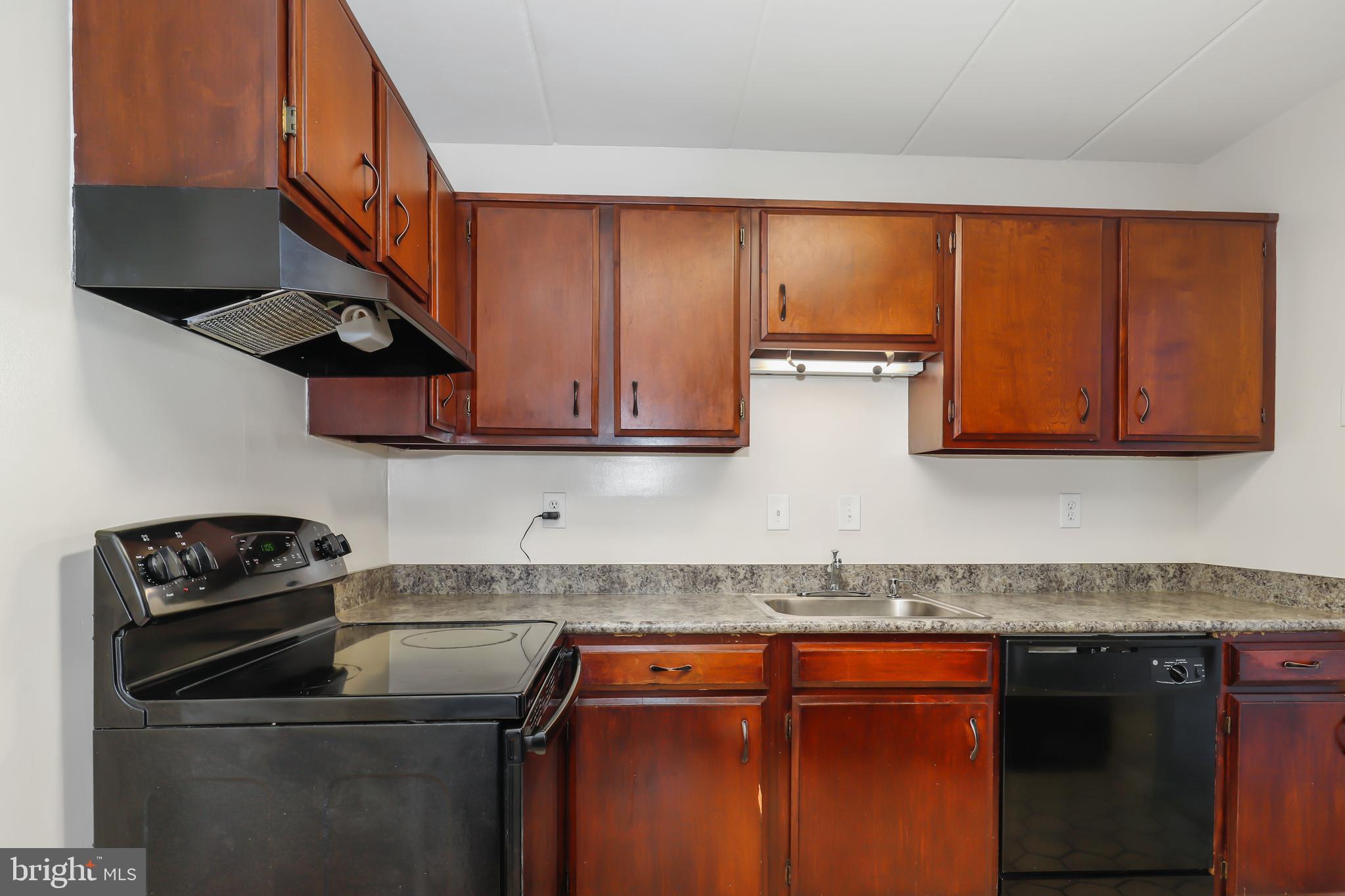 6250 Edsall Road, Unit 203 Alexandria, VA 22312 - Photo 13 of 31 a kitchen with stainless steel appliances granite countertop a stove and a microwave
