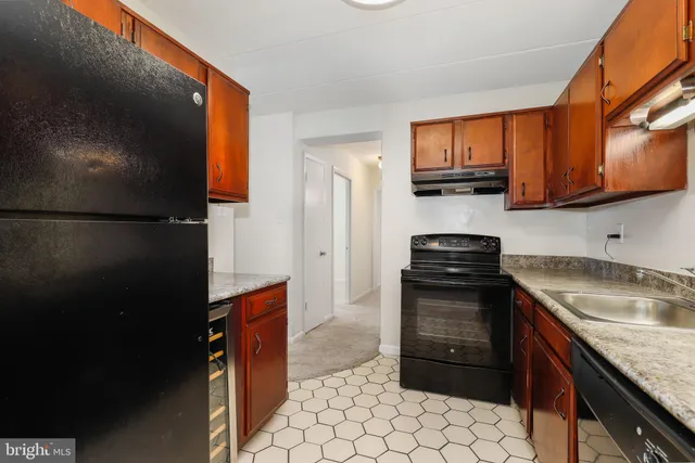 a kitchen with metallic refrigerator freezer and a dishwasher