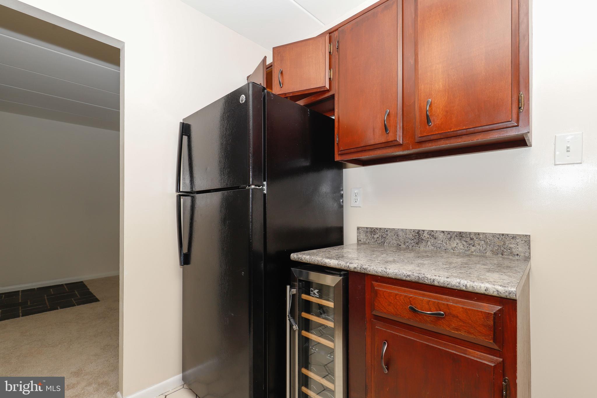 6250 Edsall Road, Unit 203 Alexandria, VA 22312 - Photo 15 of 31 a kitchen with metallic refrigerator freezer and a dishwasher