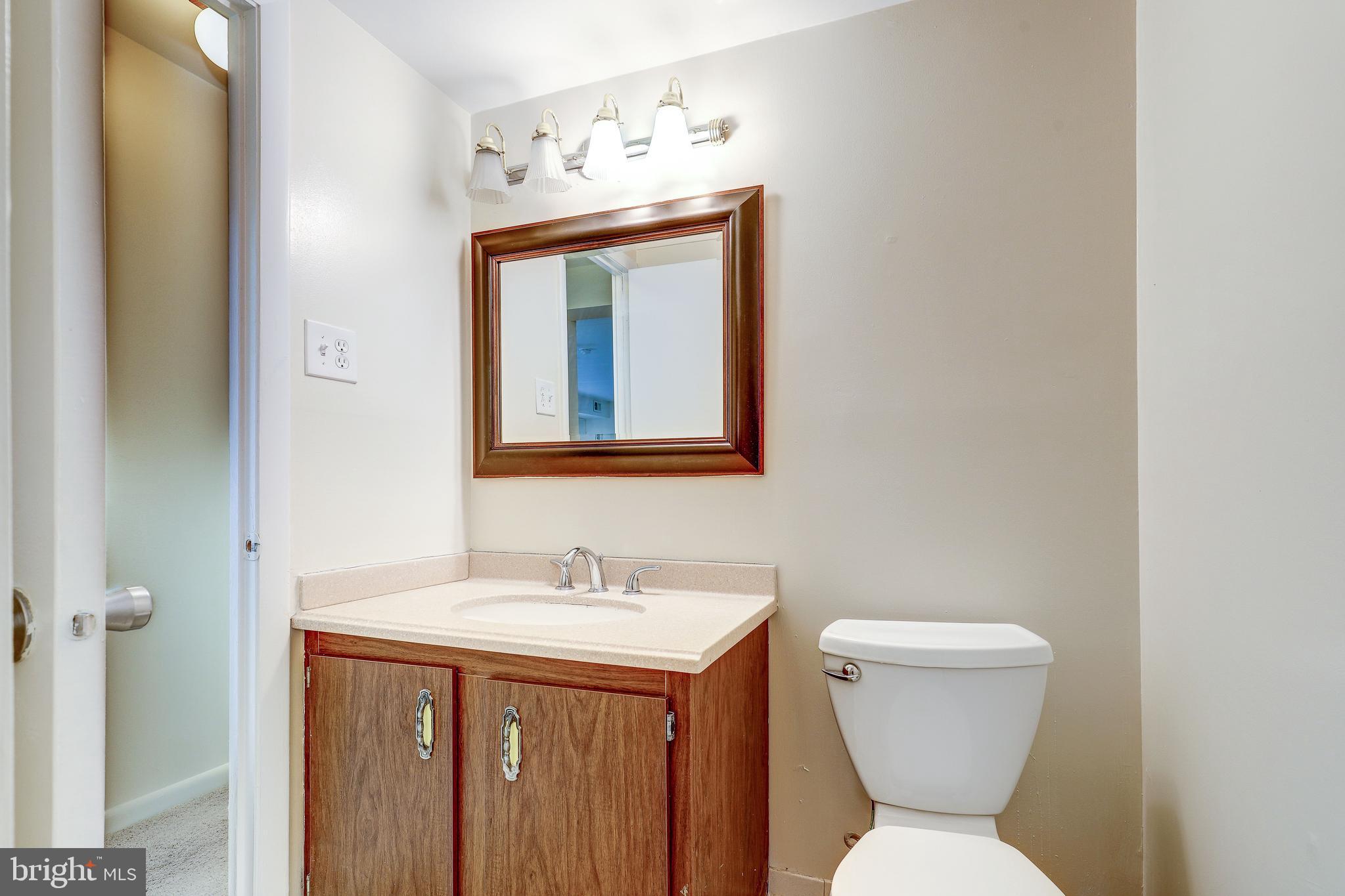 6250 Edsall Road, Unit 203 Alexandria, VA 22312 - Photo 17 of 31 a bathroom with a toilet sink and mirror