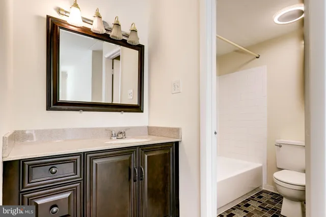 a white toilet sitting next to a white tub