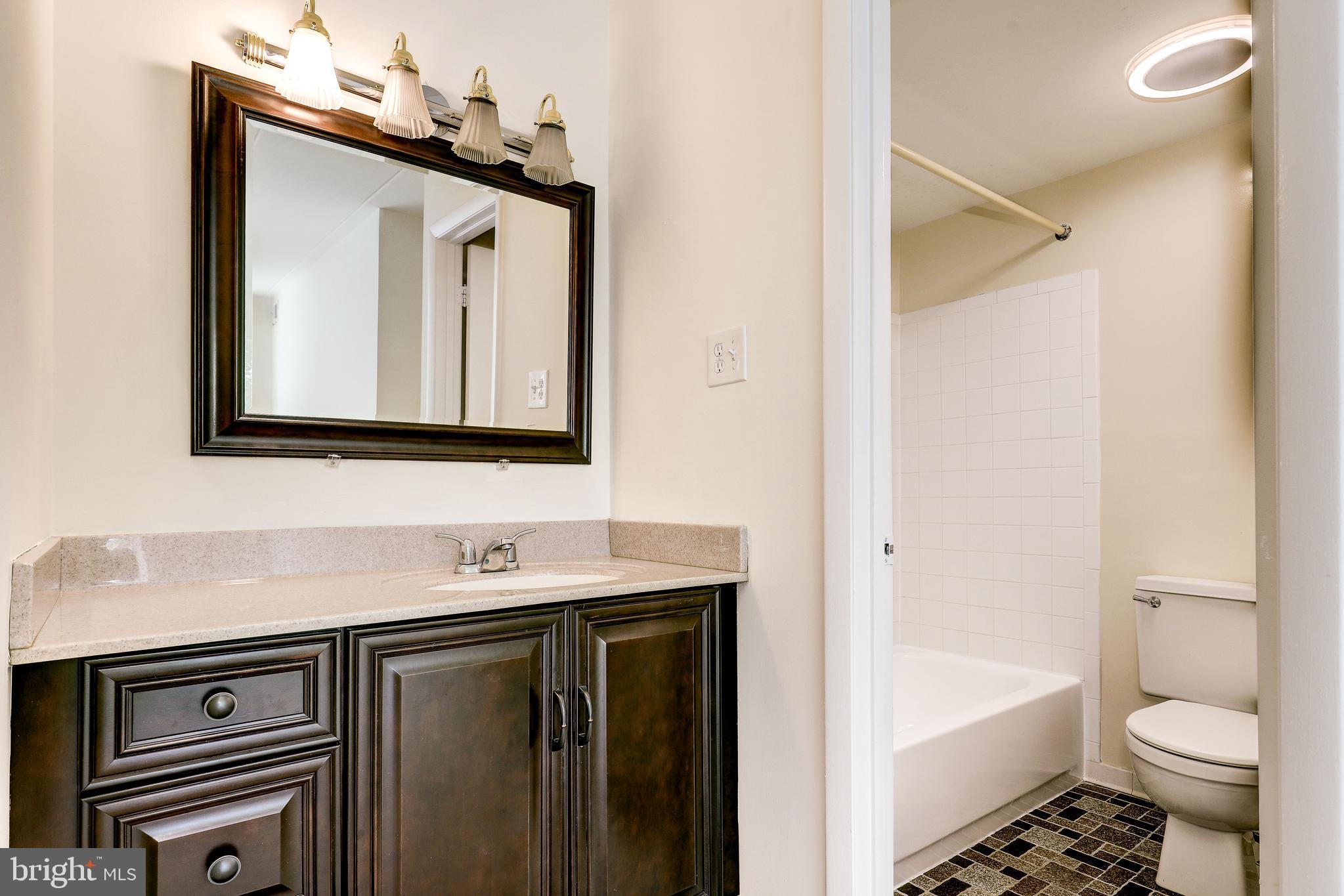 6250 Edsall Road, Unit 203 Alexandria, VA 22312 - Photo 29 of 31 a bathroom with a toilet sink and mirror