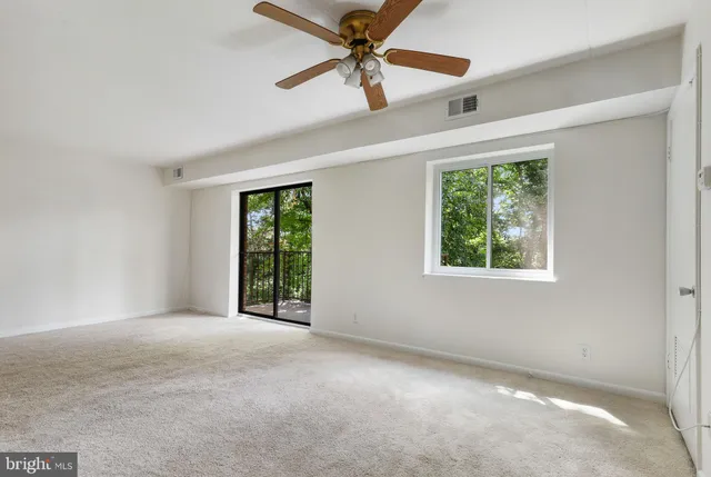 a view of a kitchen with a stove cabinets and a ceiling fan