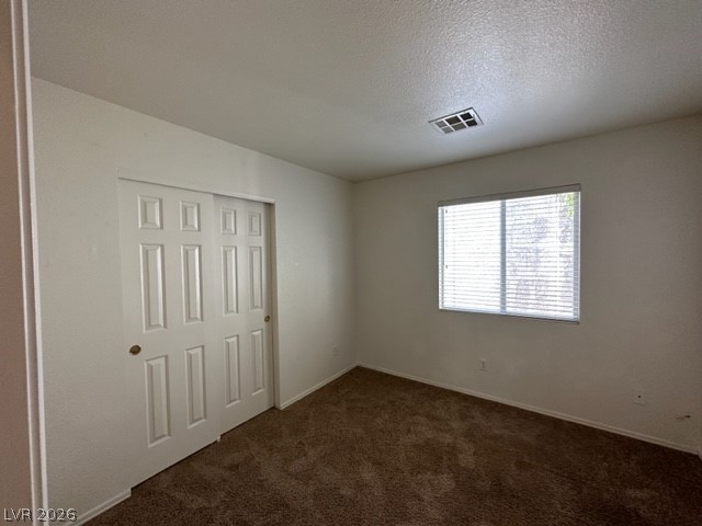 285 Spring Palms Street Henderson, NV 89012 - Photo 13 of 38 Unfurnished bedroom featuring a textured ceiling, carpet, baseboards, visible vents, and a closet