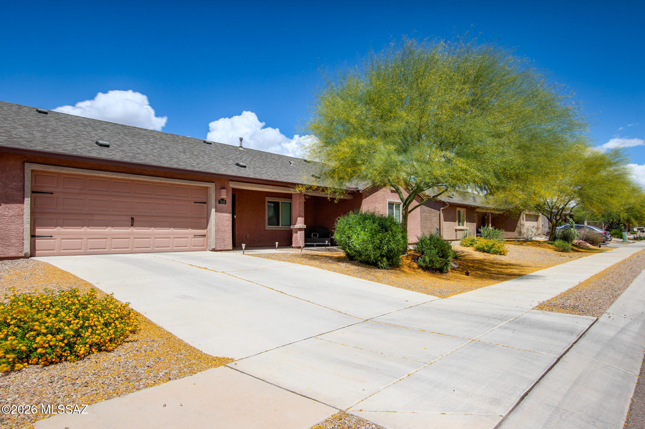 7056 South Draper Road Tucson, AZ 85757 - Photo 2 of 22 a front view of a house with a yard