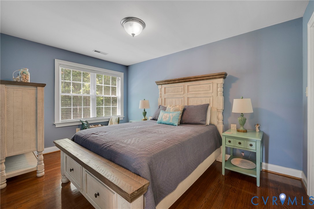 17170 Templeton Road Disputanta, VA 23842 - Photo 21 of 27 a bedroom with a bed and wooden floor