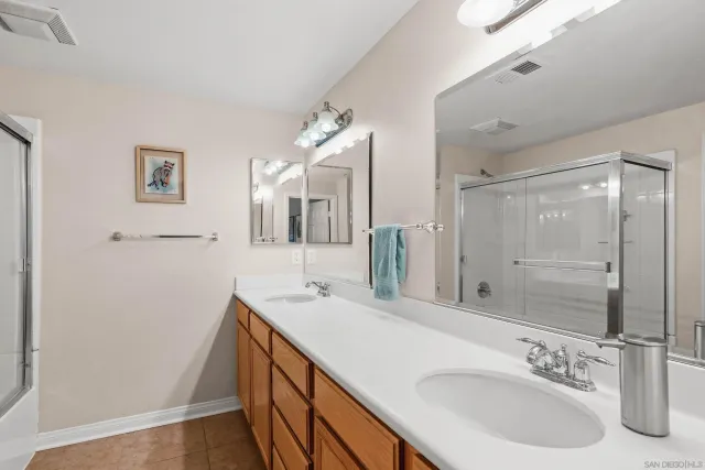 a bathroom with a sink double vanity and a mirror
