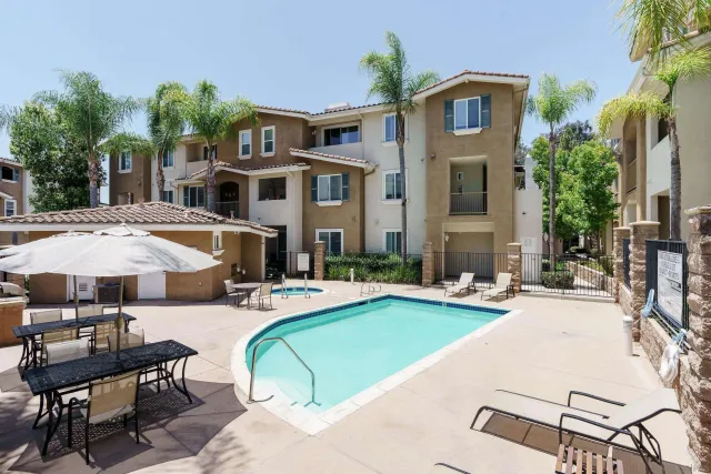 a view of a house with swimming pool and sitting area