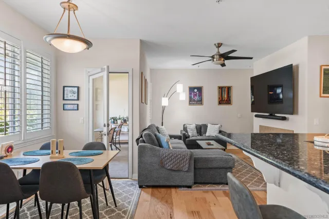 a living room with furniture a flat screen tv and a window