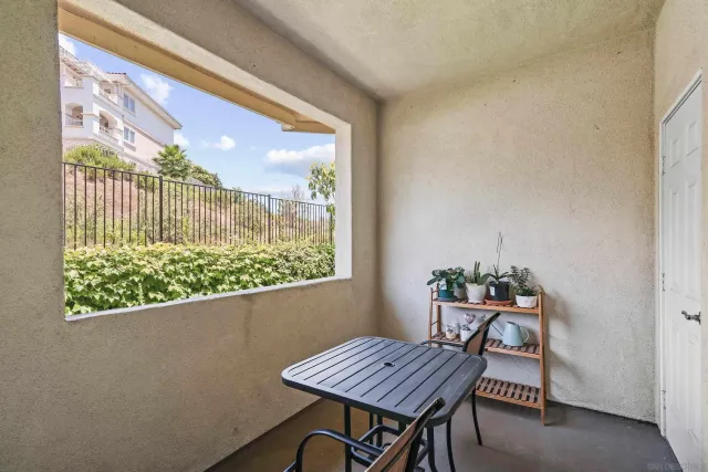 a table and chairs in a room next to a window