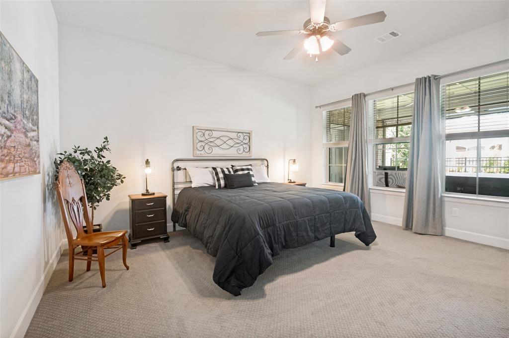 4724 Raspberry Spar Court Arlington, TX 76005 - Photo 22 of 40 a spacious bedroom with a bed and a chandelier