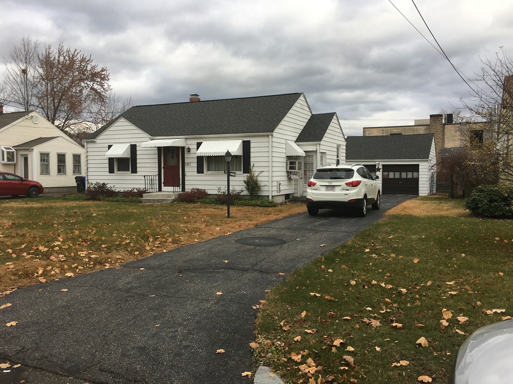 27 Kane Street Springfield, MA 01129 - Photo 1 of 6 a front view of a house with a garden and yard