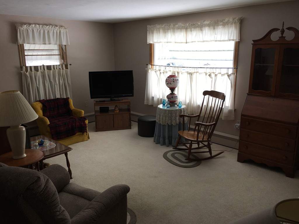 27 Kane Street Springfield, MA 01129 - Photo 2 of 6 a living room with furniture and a flat screen tv