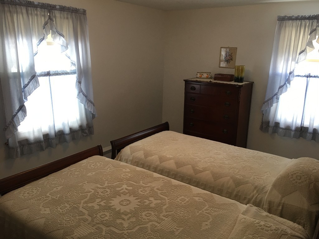 27 Kane Street Springfield, MA 01129 - Photo 4 of 6 a bedroom with a bed and a window