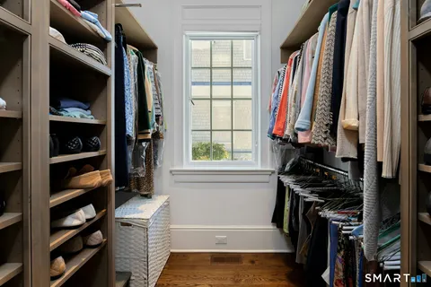 a view of walk in closet with clothes and shoes