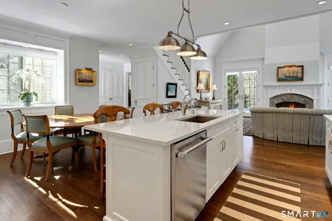 a kitchen with stainless steel appliances granite countertop a sink a stove and a refrigerator