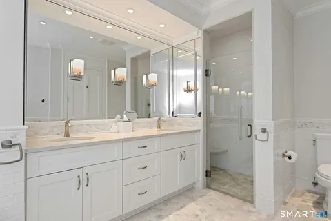 a bathroom with a double vanity sink mirror double and shower