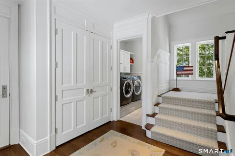 a view of entryway with wooden floor and windows