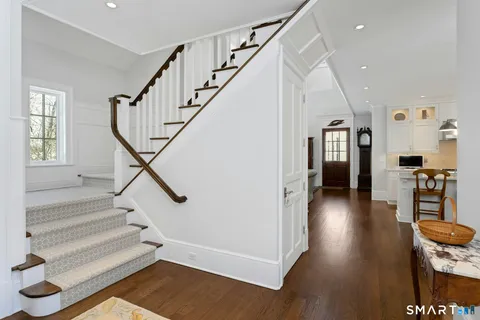 a view of entryway and hall with wooden floor
