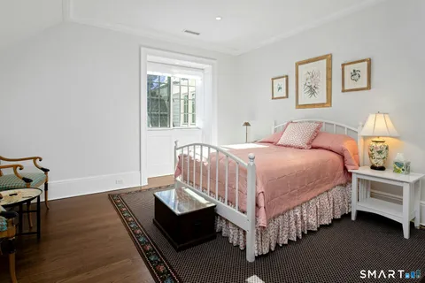 a bedroom with a bed couch and a window