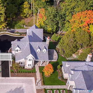 an aerial view of a house with a yard basket ball court and outdoor seating