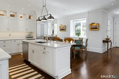 a kitchen with stainless steel appliances granite countertop a sink stove and wooden floor
