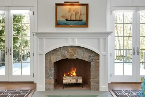 a living room with a fireplace and a window