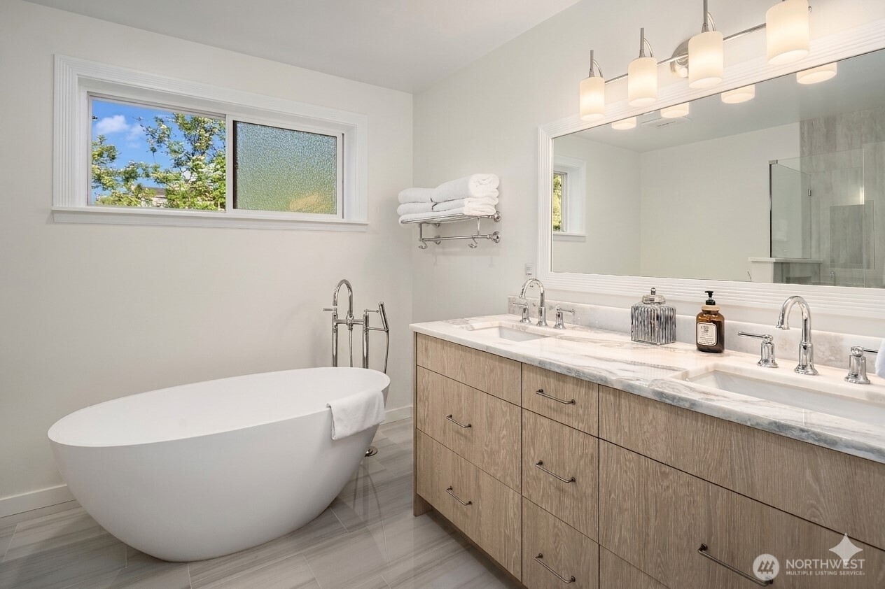 4014 Southwest 98th Street Seattle, WA 98136 - Photo 17 of 36 a bathroom with a white tub a sink and mirror