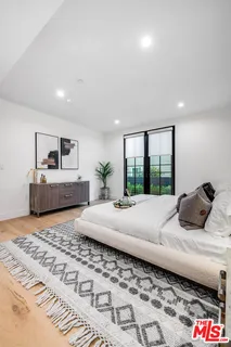 a bedroom with a large bed and a window