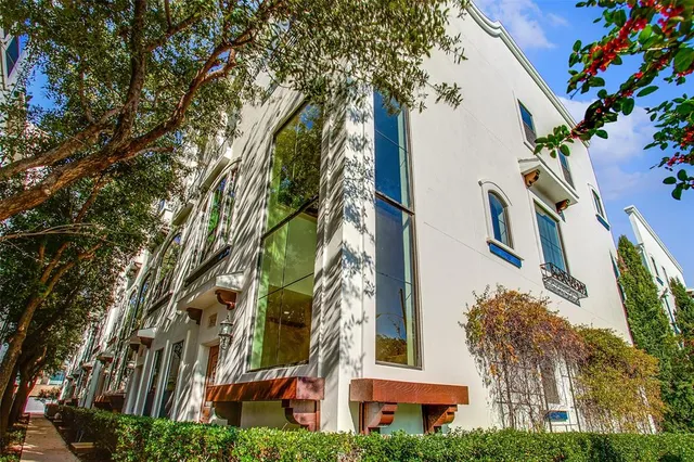 an aerial view of a residential apartment building with a yard and potted plants