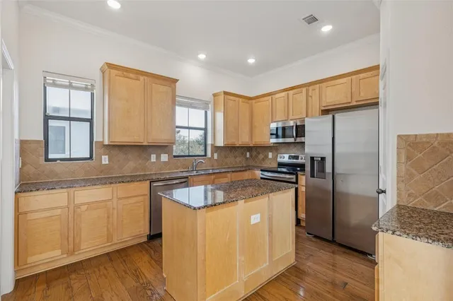 a kitchen with a refrigerator sink and cabinets
