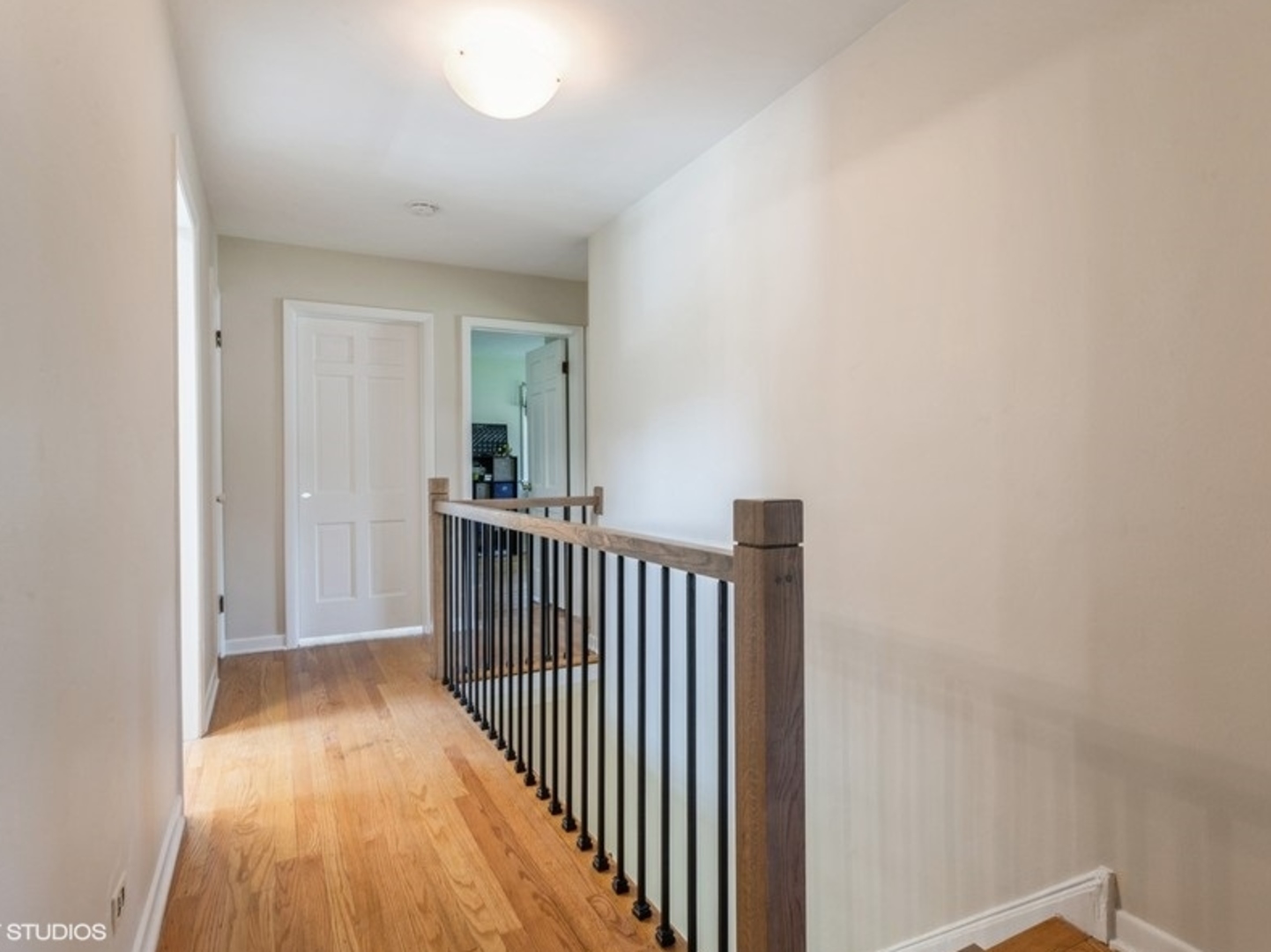 2220 Walnut Street Park Ridge, IL 60068 - Photo 12 of 25 a view of a hallway with wooden floor and a bathroom