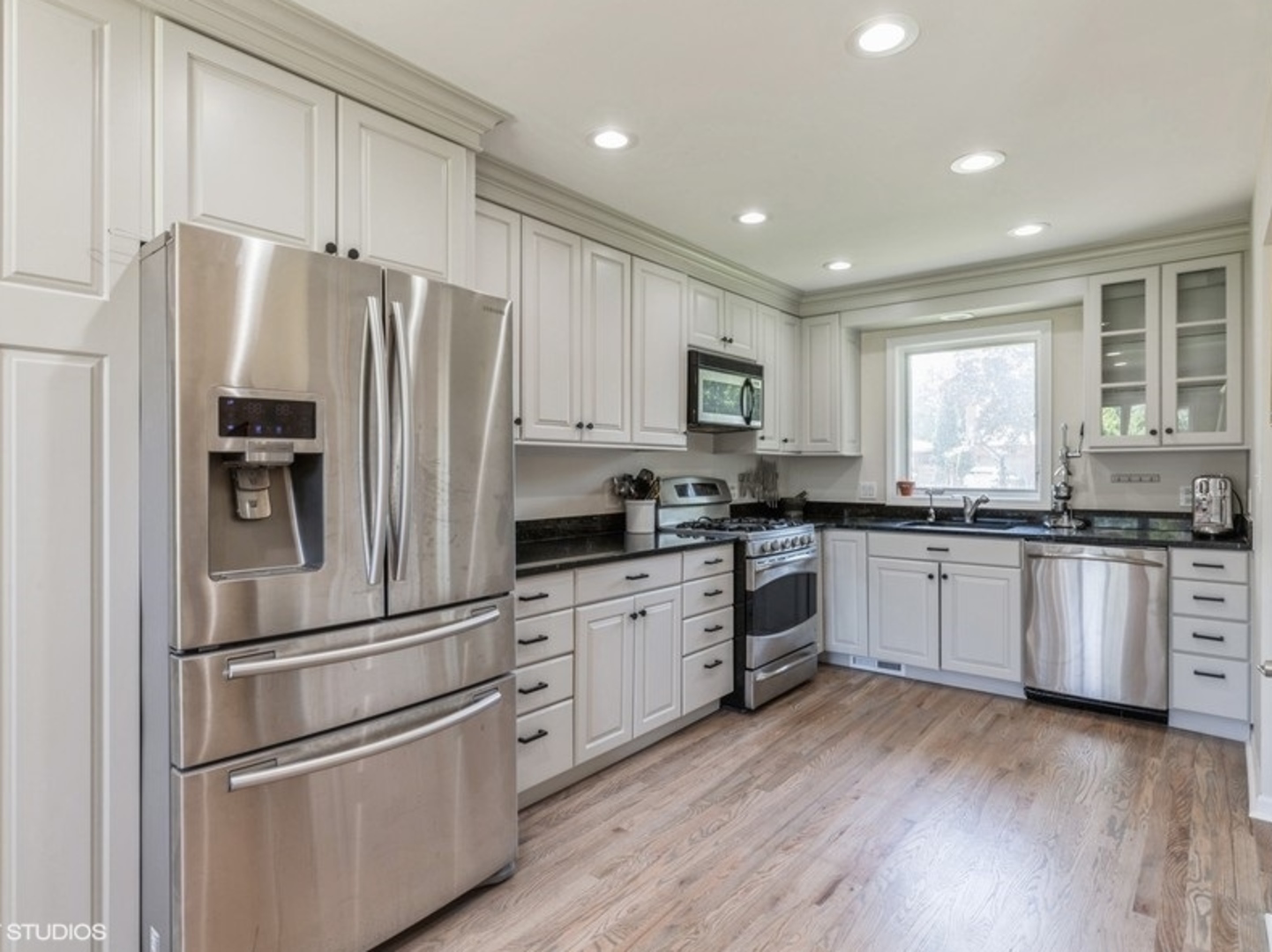 2220 Walnut Street Park Ridge, IL 60068 - Photo 4 of 25 a kitchen with white cabinets and stainless steel appliances