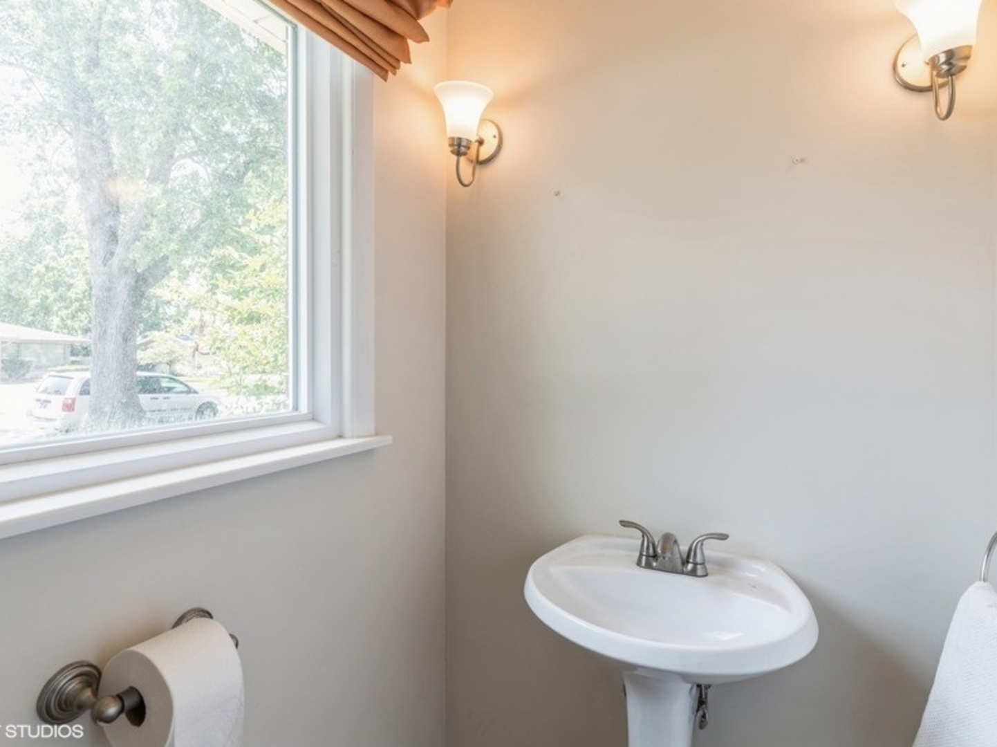 2220 Walnut Street Park Ridge, IL 60068 - Photo 9 of 25 a bathroom with a sink a mirror and a window