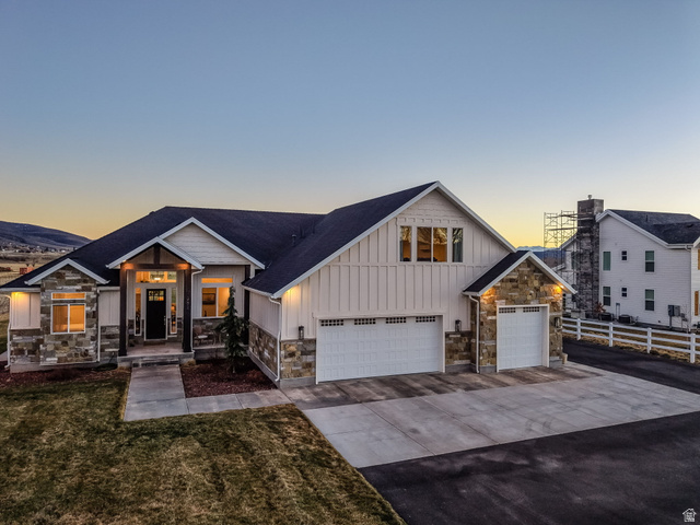 352 East Boulderville Road Oakley, UT 84055 - Photo 2 of 62 View of front of house with board and batten siding, stone siding, concrete driveway, and a garage