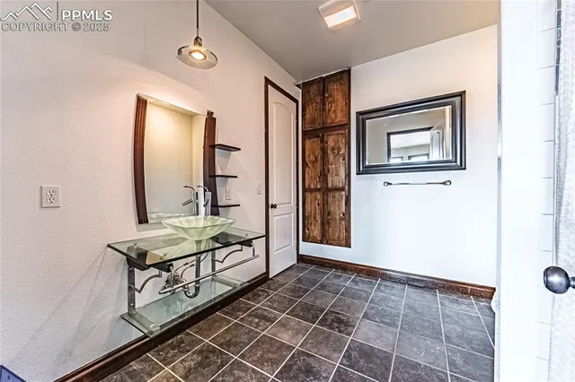 a dining room with furniture large windows and a chandelier