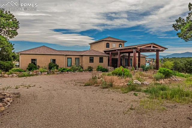 a spacious bedroom with a large bed and a chandelier
