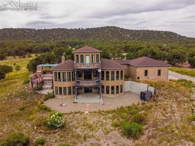 a living room with furniture a chandelier and large window