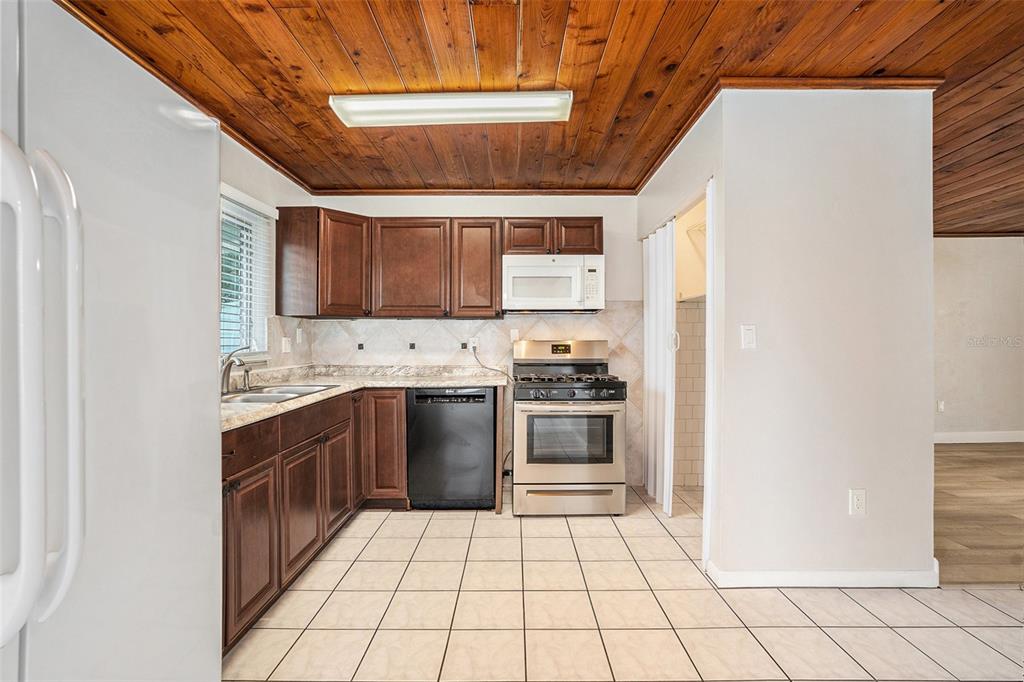 5305 Whiteway Drive Temple Terrace, FL 33617 - Photo 12 of 22 a kitchen with a stove a sink and a refrigerator