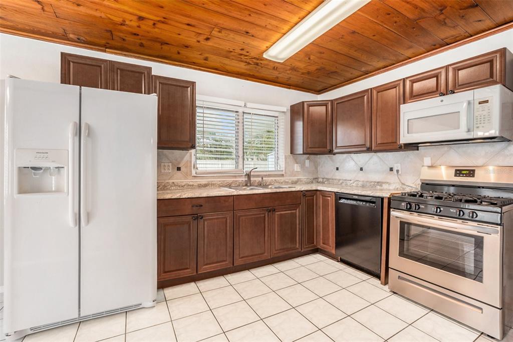 5305 Whiteway Drive Temple Terrace, FL 33617 - Photo 13 of 22 a kitchen with stainless steel appliances granite countertop a refrigerator and a stove top oven
